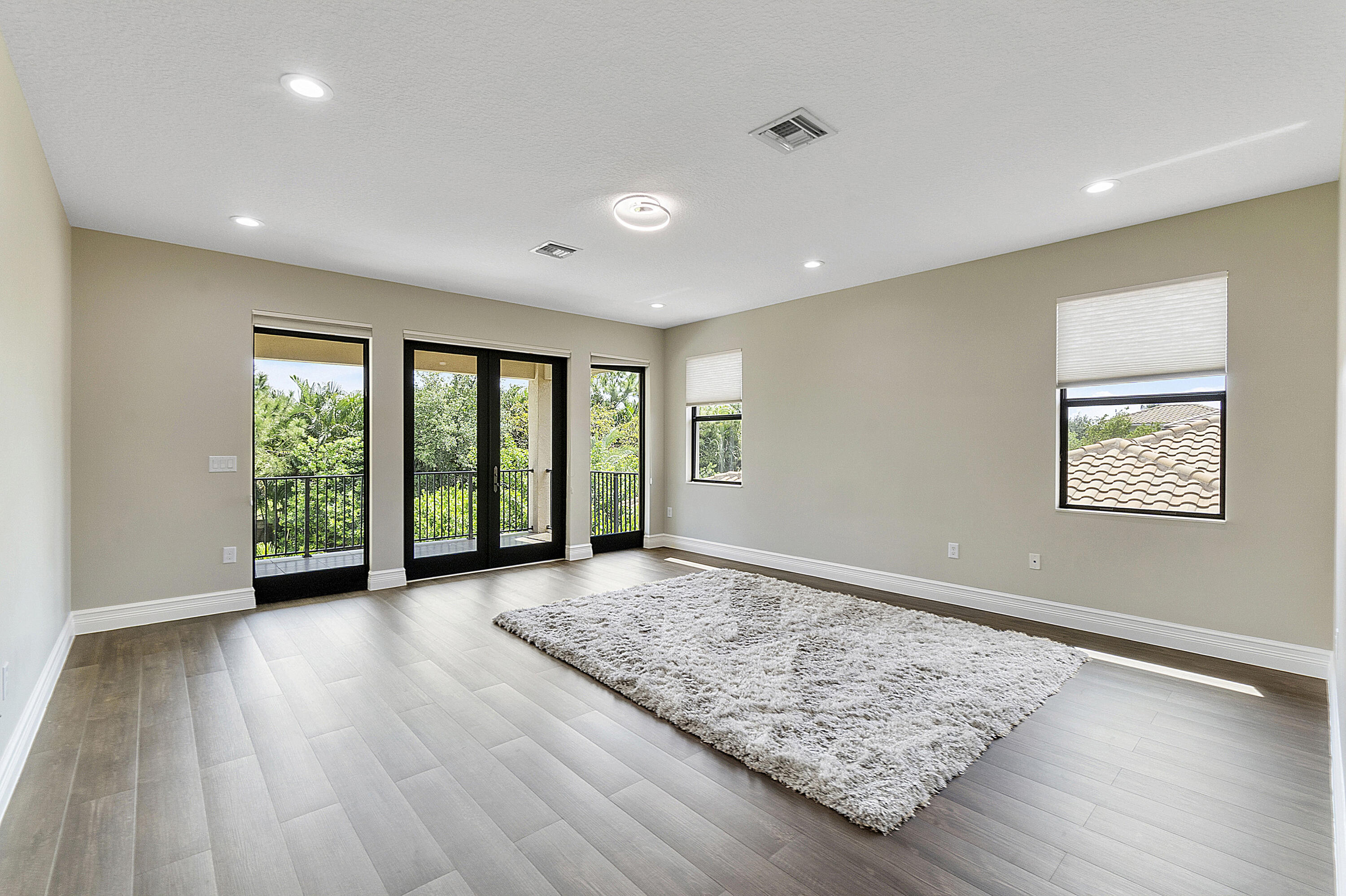 16897 Pierre Circle Delray Beach, FL 33446 - Photo 20 of 37 a view of an empty room with wooden floor and a window