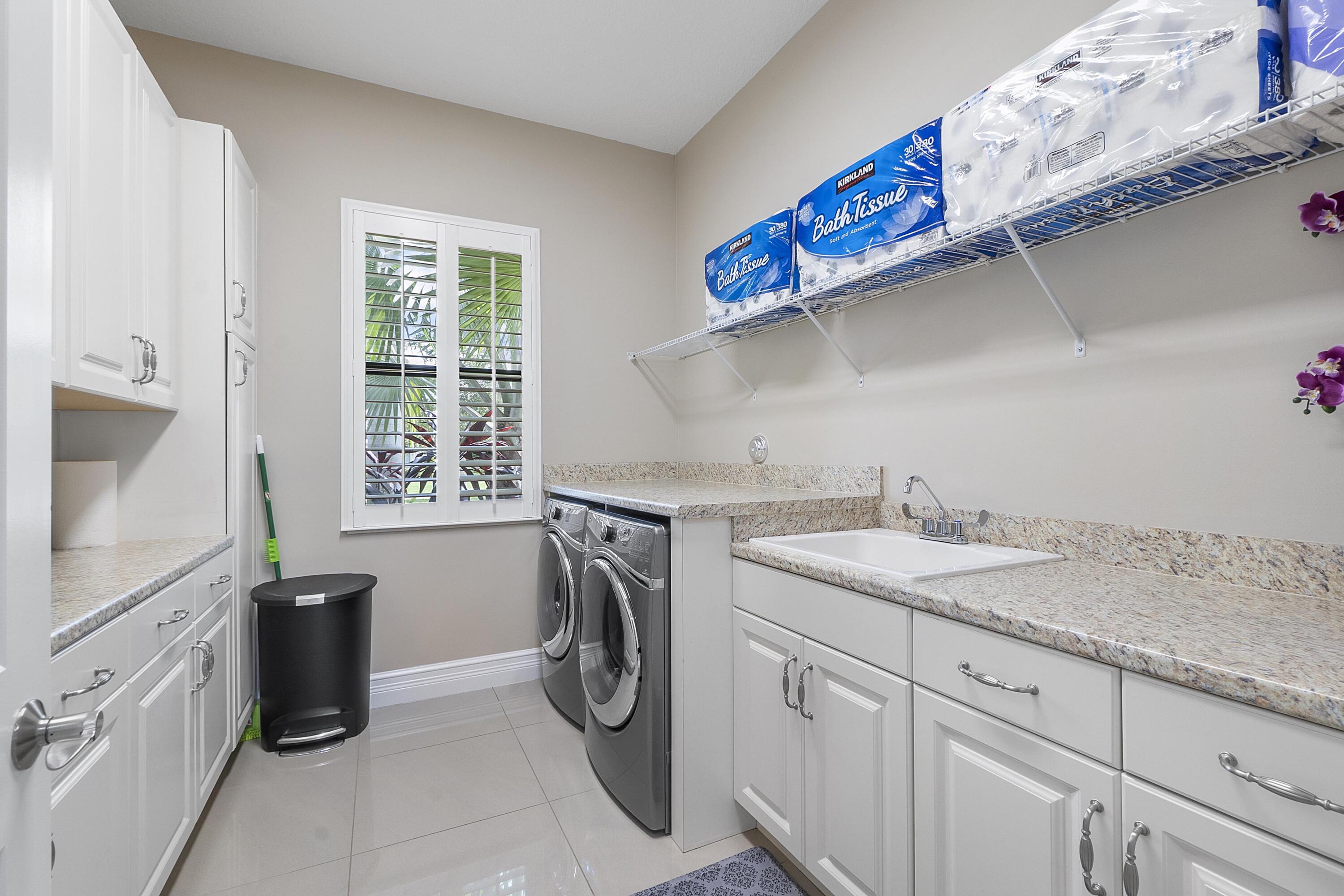 16897 Pierre Circle Delray Beach, FL 33446 - Photo 24 of 37 a utility room with a sink a washer and dryer