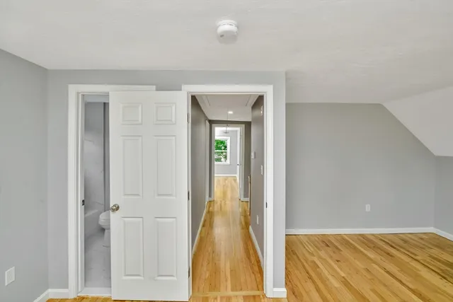 a view of hallway with wooden floor