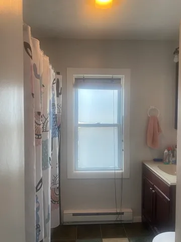 a bathroom with a shower sink and mirror