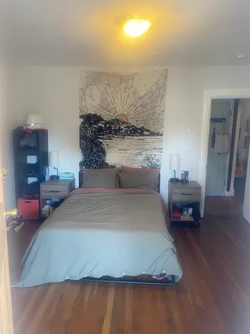 a bedroom with a bed and a chair