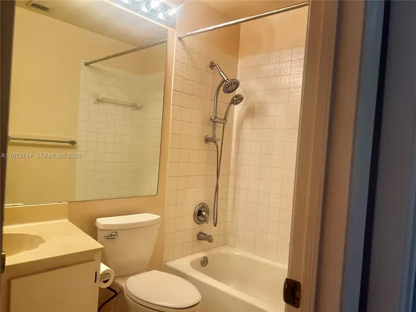 a bathroom with a shower a toilet and a sink