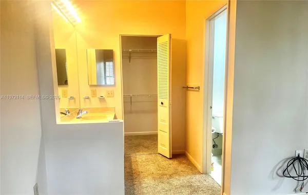 a view of a bathroom with a tub shower and a sink