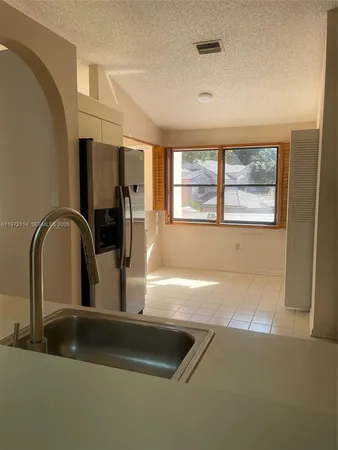 a kitchen with a sink a counter top space and a window