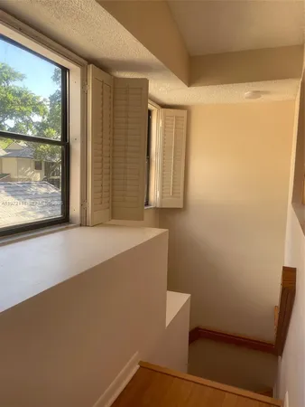 a view of room with window and wooden floor