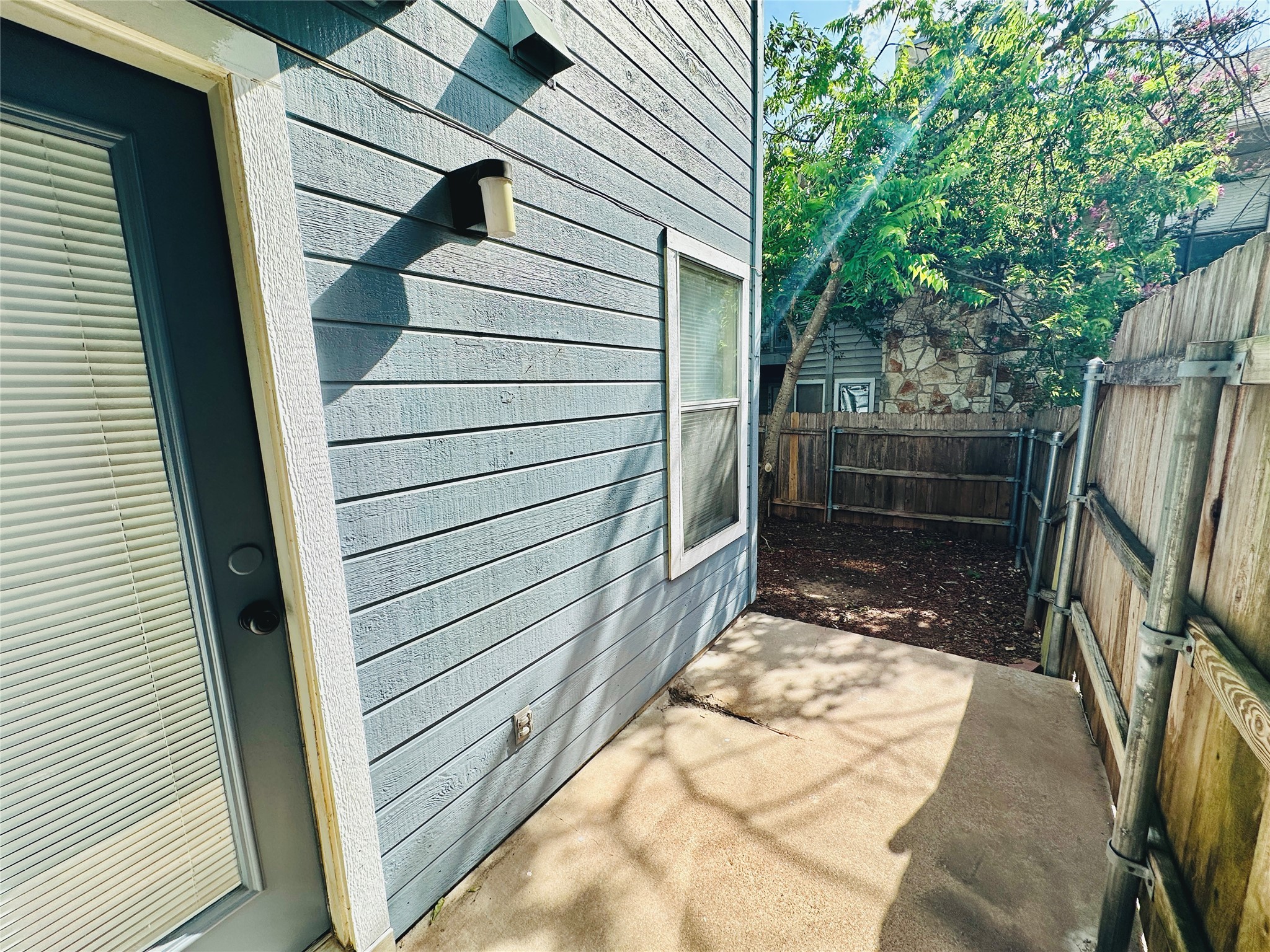 8814 Schick Road, Unit C Austin, TX 78729 - Photo 33 of 35 A private fenced patio area offers a charming outdoor retreat, perfect for relaxation or small gatherings.