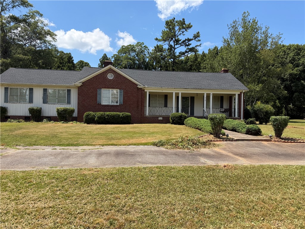 715 Concord Road Anderson, SC 29621 - Photo 1 of 24 A classic brick and siding home offers a welcoming facade with a covered porch and mature landscaping.