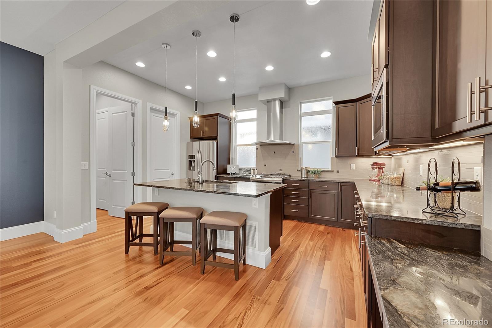 3693 Silverton Street Boulder, CO 80301 - Photo 15 of 50 a kitchen with stainless steel appliances granite countertop wooden cabinets a sink stove and a granite counter top