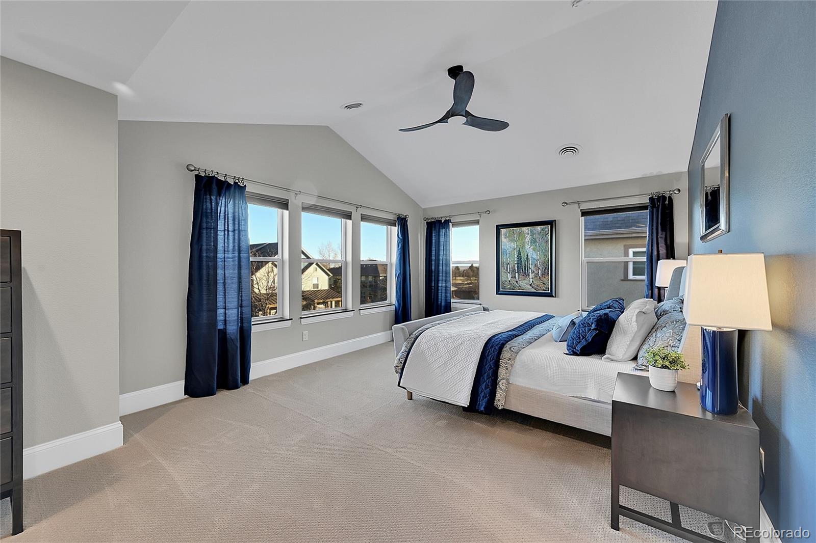 3693 Silverton Street Boulder, CO 80301 - Photo 18 of 50 a spacious bedroom with a large bed and a chandelier