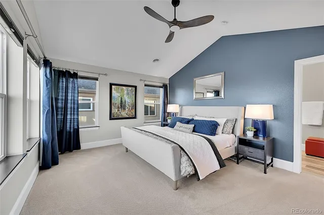 a spacious bedroom with a bed couch and a window