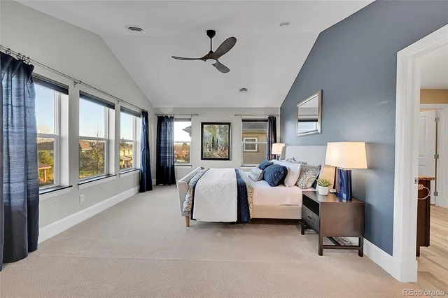 a bedroom with a bed couch and window