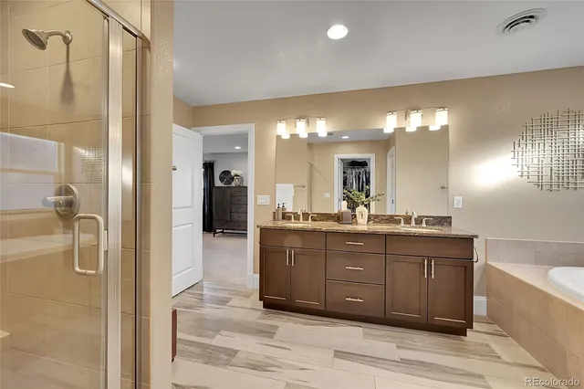 a bathroom with a granite countertop sink mirror and shower