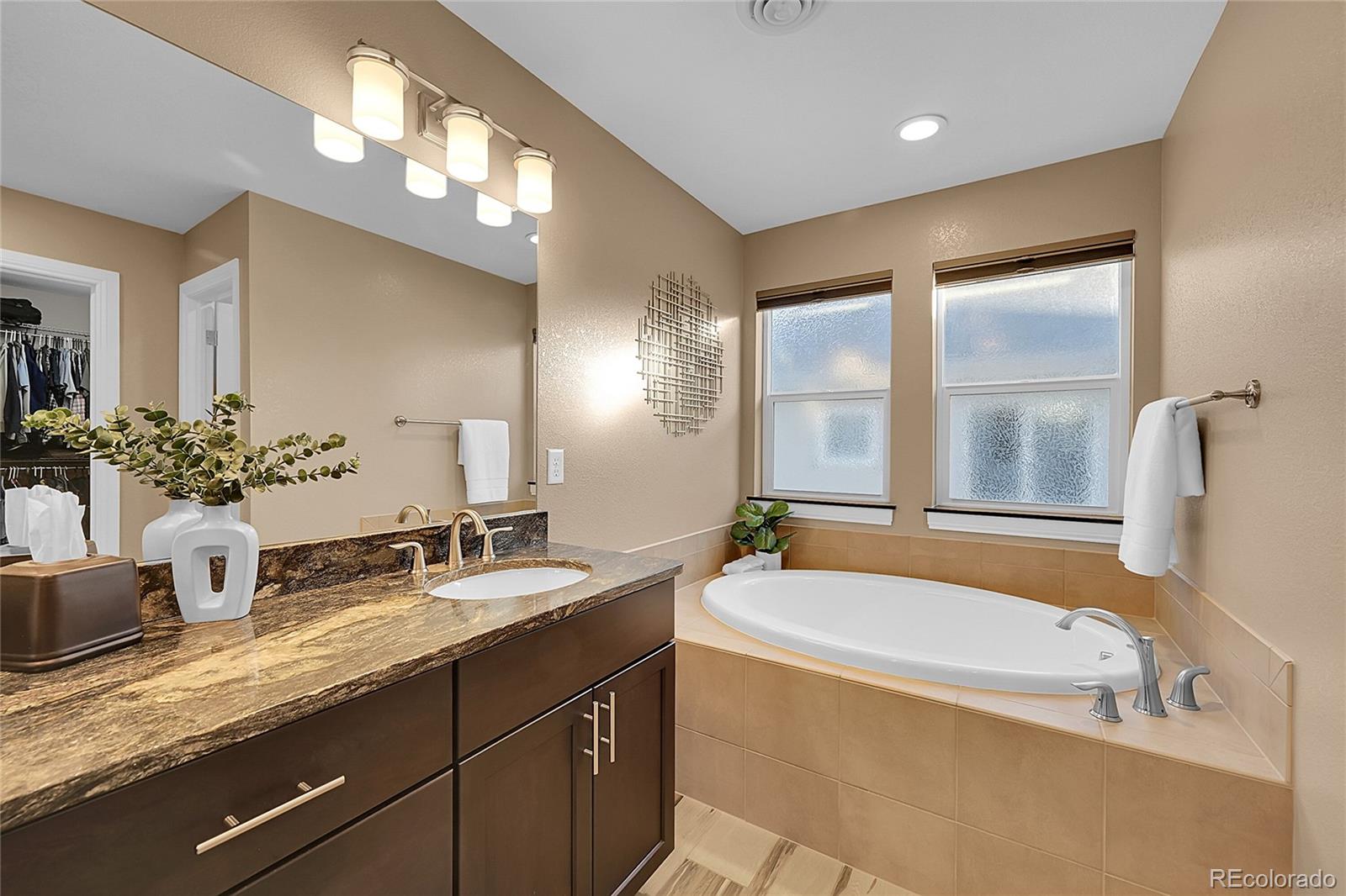 3693 Silverton Street Boulder, CO 80301 - Photo 27 of 50 a bathroom with a tub a sink double vanity and a mirror