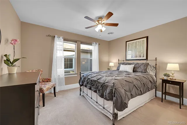 a spacious bedroom with a bed and a table in it