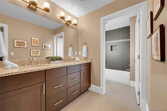 a bathroom with a granite countertop sink mirror and