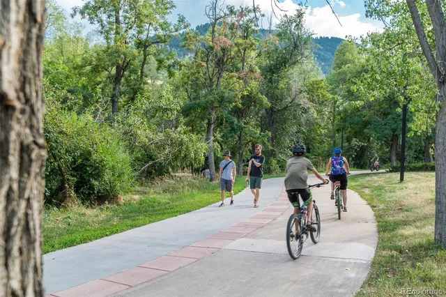 a view of a sign of golf club on a wall under a tree