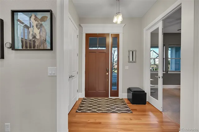 a bedroom with a bed and a painting on the wall