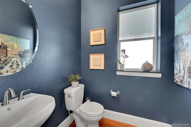 a white toilet sitting next to a bathroom sink