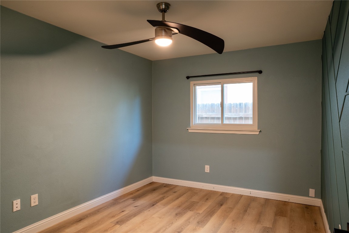 9828 Briar Ridge Drive Austin, TX 78748 - Photo 10 of 17 Bedroom 2 featuring a ceiling fan and accent wall.