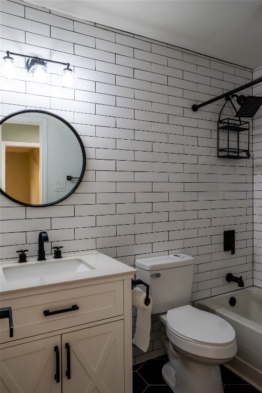 9828 Briar Ridge Drive Austin, TX 78748 - Photo 13 of 17 Bathroom 2 featuring modern tile carried all the way behind the vanity and mirror. A shower tub combo to accommodate little ones or furry ones.