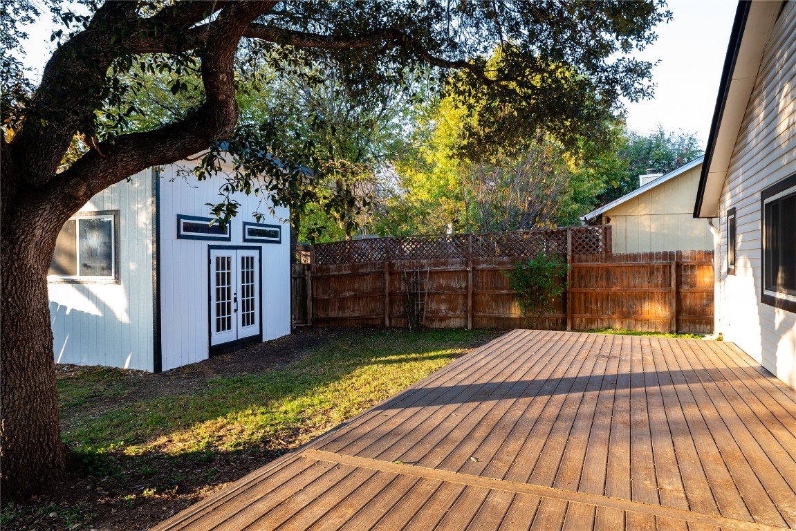 9828 Briar Ridge Drive Austin, TX 78748 - Photo 15 of 17 Back yard showing large outbuilding which has multiple windows.