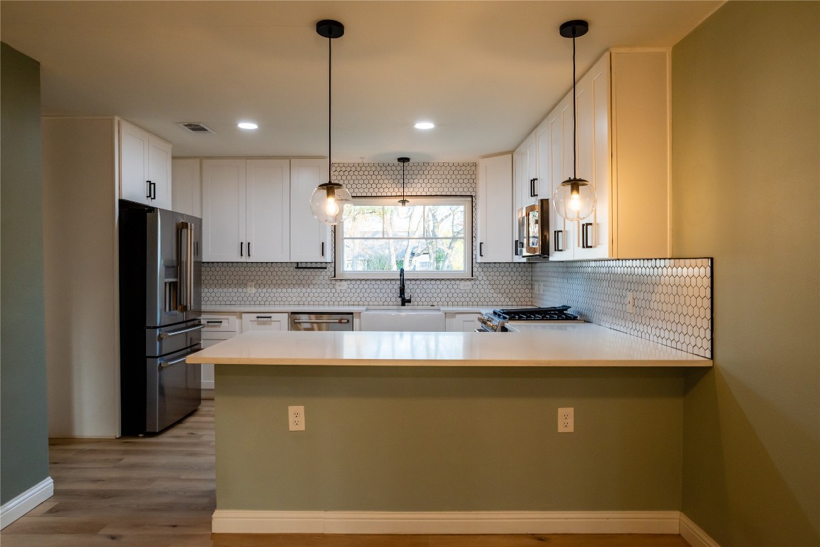 9828 Briar Ridge Drive Austin, TX 78748 - Photo 3 of 17 Peninsula with counter overhand to accommodate additional seating.