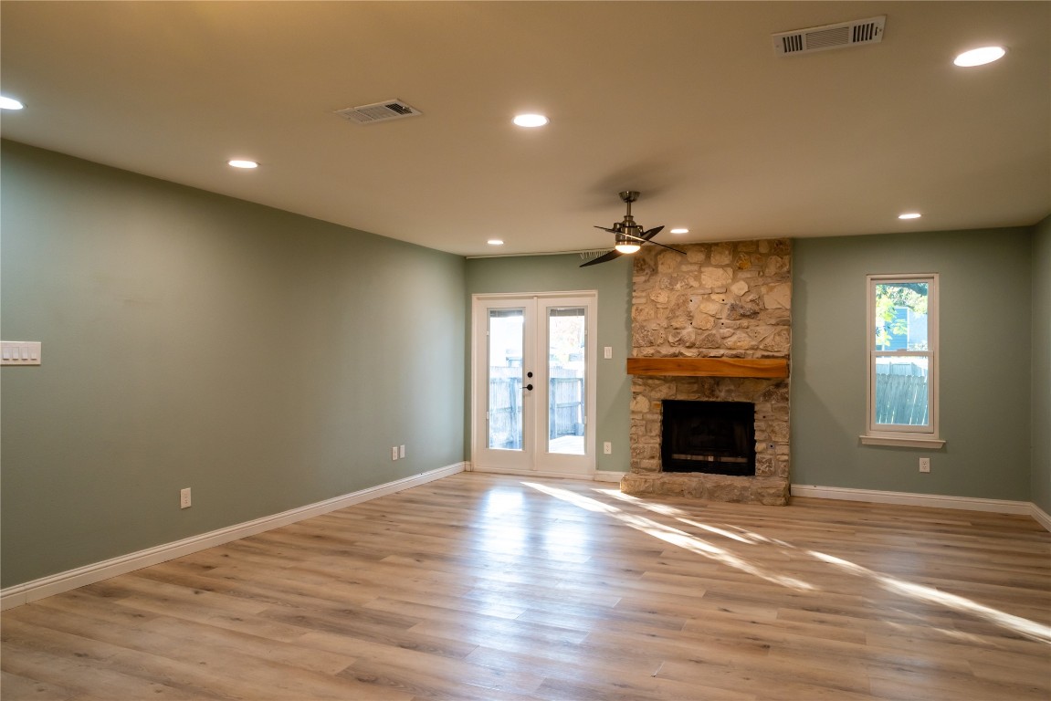 9828 Briar Ridge Drive Austin, TX 78748 - Photo 6 of 17 Living room with ceiling fan and French doors to the back yard.