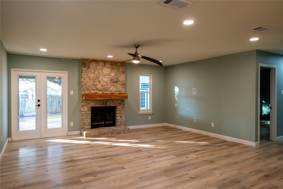 9828 Briar Ridge Drive Austin, TX 78748 - Photo 7 of 17 Living room featuring a gas fireplace and lots of natural light.