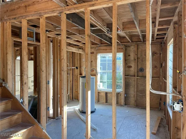 a view of a hallway with wooden floor and entryway
