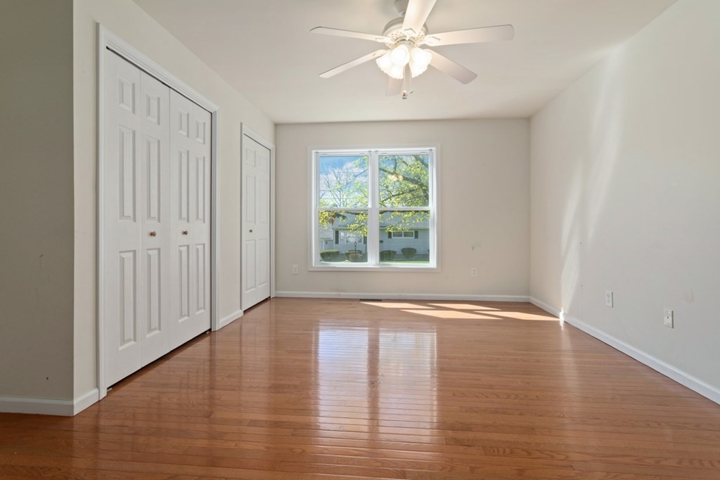 2 Earley Road Peabody, MA 01960 - Photo 19 of 30 an empty room with wooden floor chandelier fan and windows