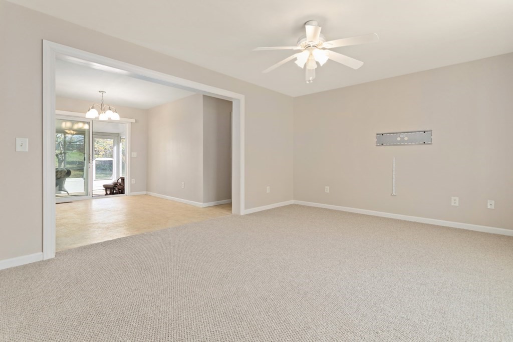 2 Earley Road Peabody, MA 01960 - Photo 4 of 30 an empty room with chandelier fan and windows