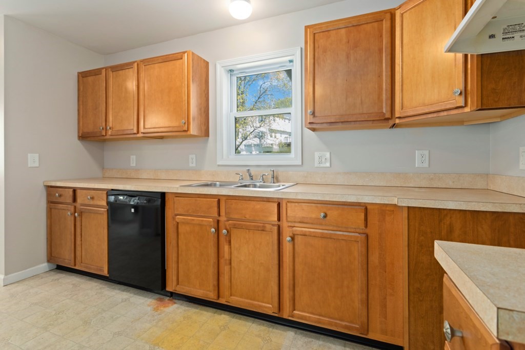 2 Earley Road Peabody, MA 01960 - Photo 7 of 30 a kitchen with stainless steel appliances granite countertop a sink and cabinets with wooden floor