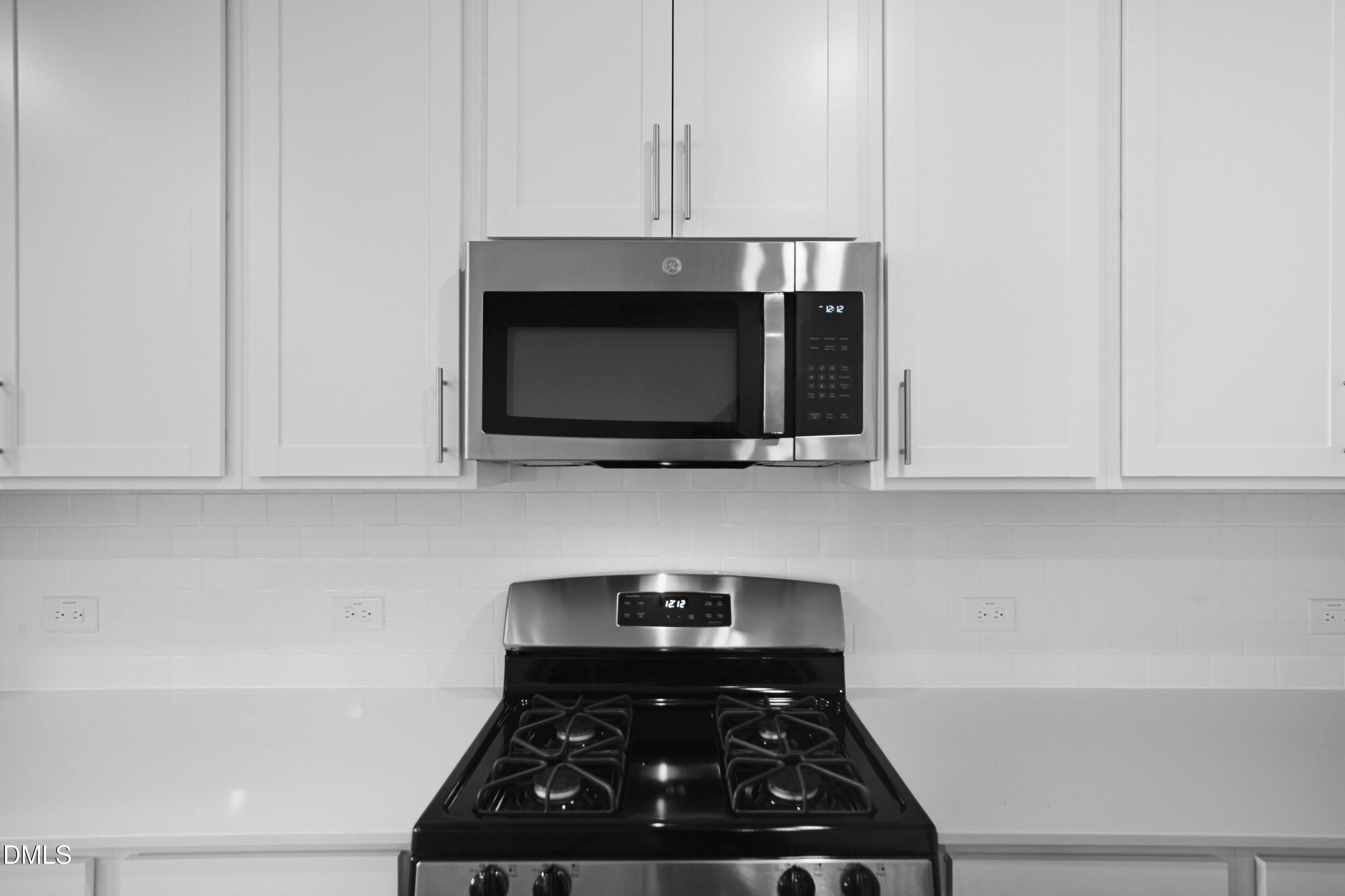 2915 Hickory Fld Drive Raleigh, NC 27616 - Photo 9 of 30 a kitchen with a stove and a microwave