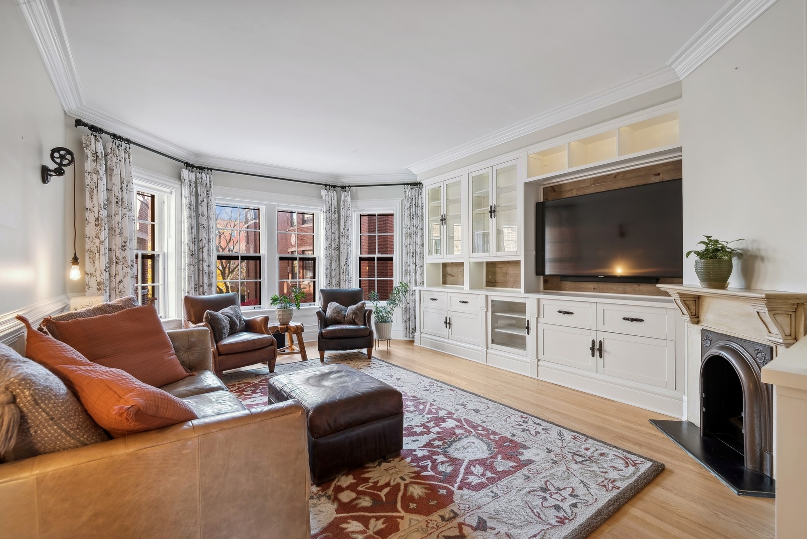 360 Ridge Avenue, Unit 102 Evanston, IL 60202 - Photo 3 of 16 a living room with furniture and a flat screen tv