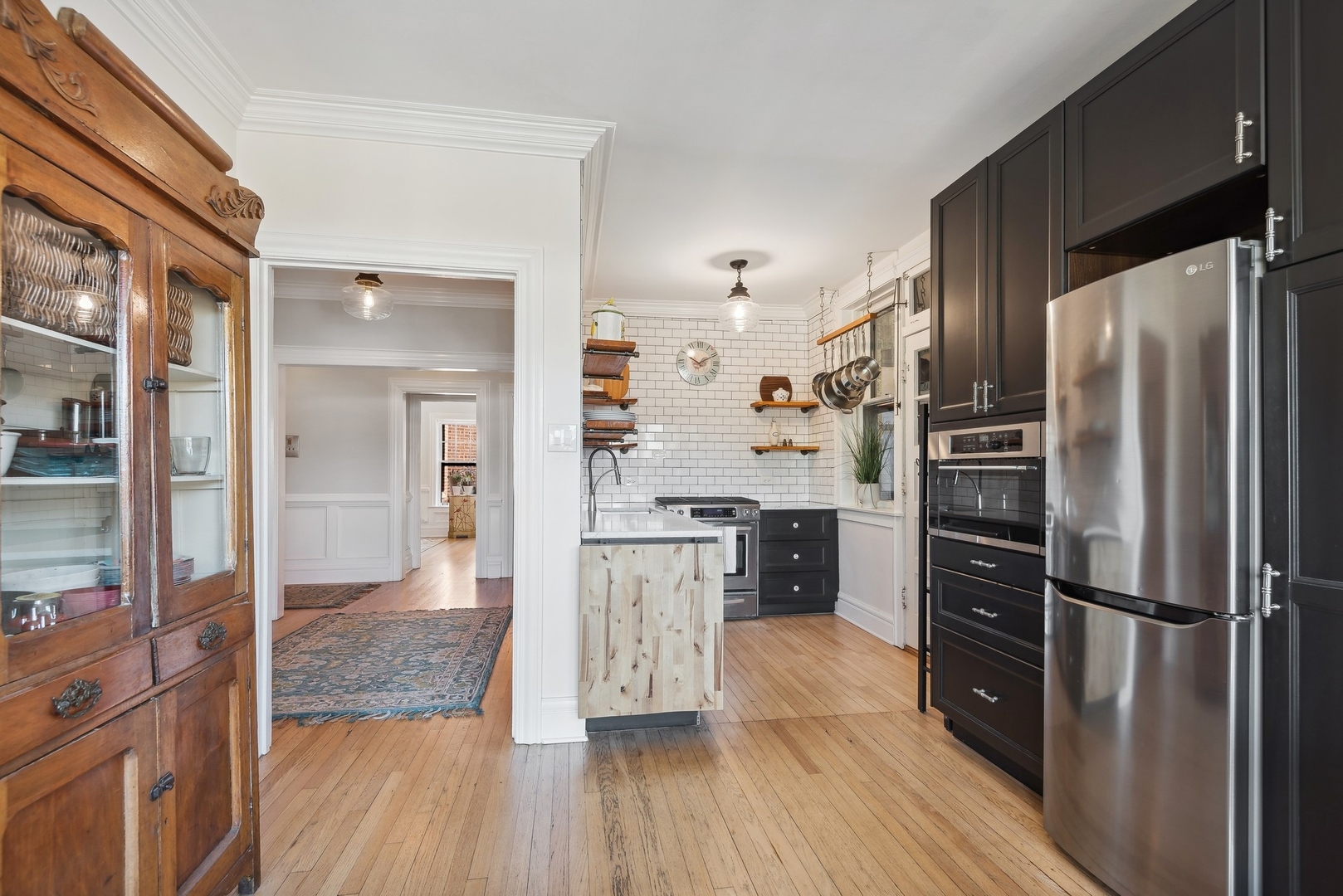 360 Ridge Avenue, Unit 102 Evanston, IL 60202 - Photo 5 of 16 a kitchen with a refrigerator a sink and a stove top oven