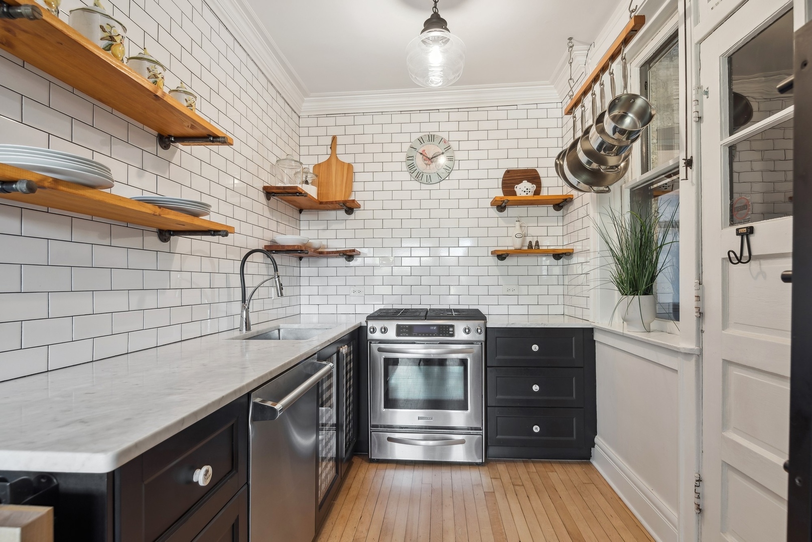 360 Ridge Avenue, Unit 102 Evanston, IL 60202 - Photo 6 of 16 a kitchen with stainless steel appliances granite countertop a sink and wooden cabinets