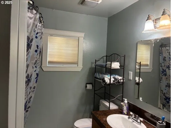 a bathroom with a sink toilet and mirror