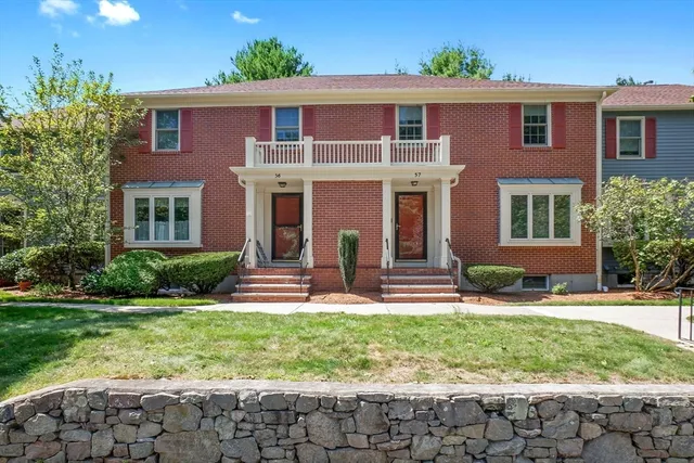 a front view of house with yard and green space
