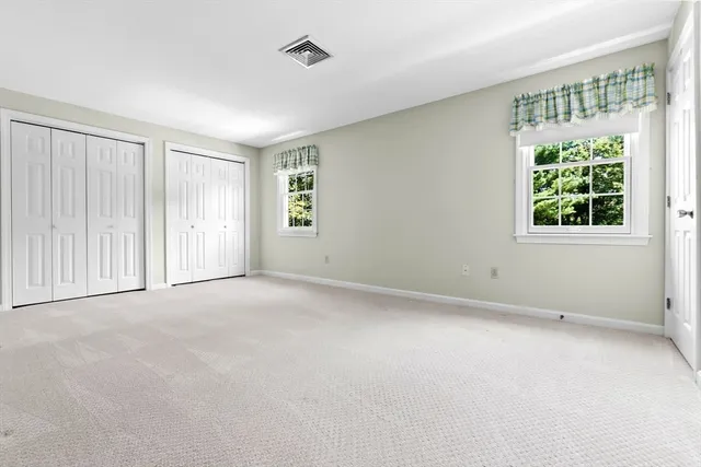 en empty room with windows and closet