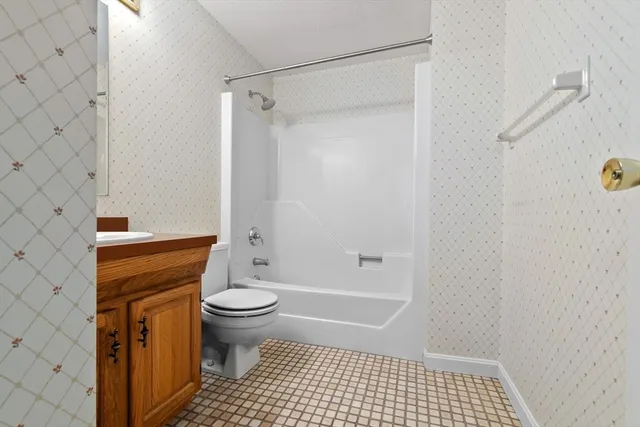 a bathroom with a sink and mirror with toilet