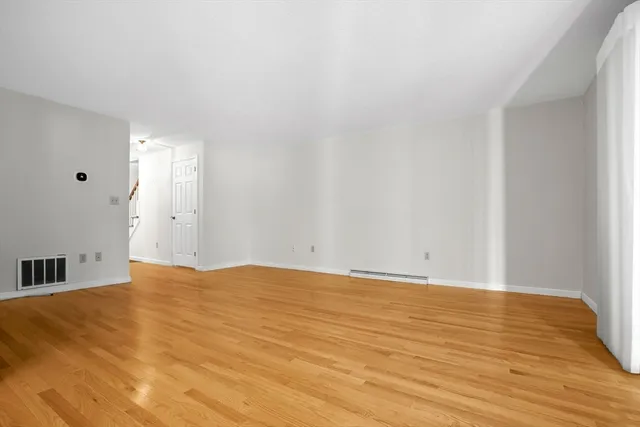a view of an empty room and wooden floor