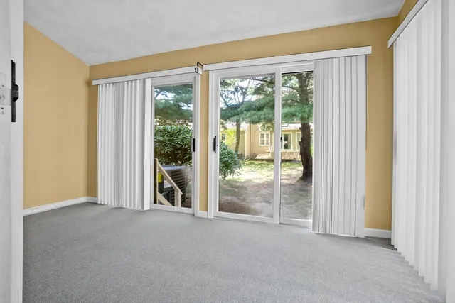 a view of an empty room with sliding glass door