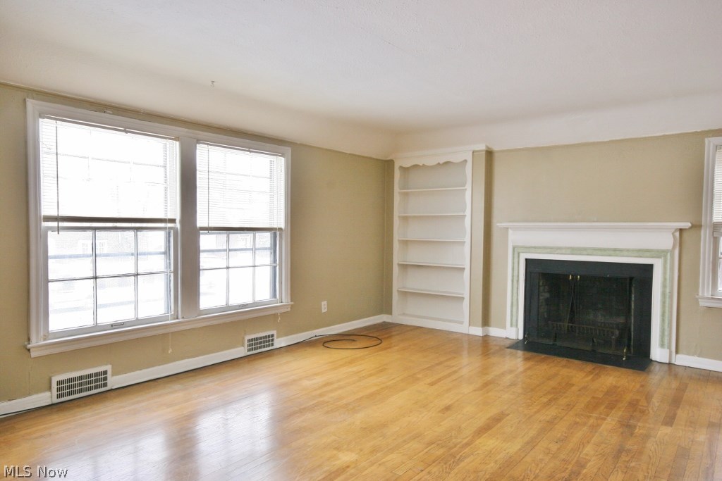 13602 Cedar Road Cleveland, OH 44118 - Photo 5 of 11 Spacious living room with fireplace and hardwood floors.