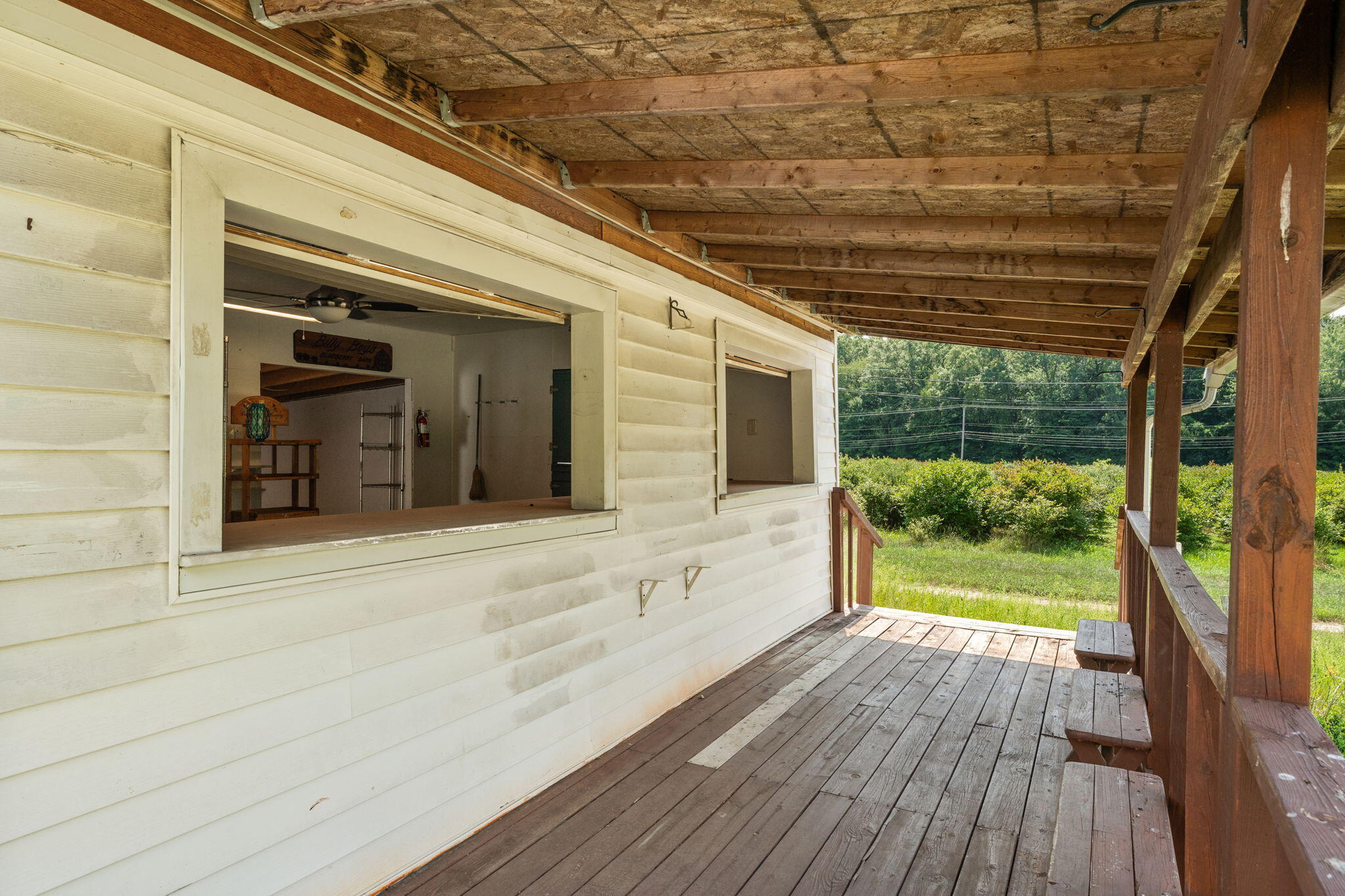 650 Freyer Road Michigan City, IN 46360 - Photo 27 of 49 a view of a porch with wooden floor and floor to ceiling window