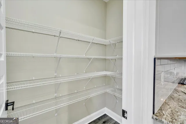 a view of walk in closet with empty racks