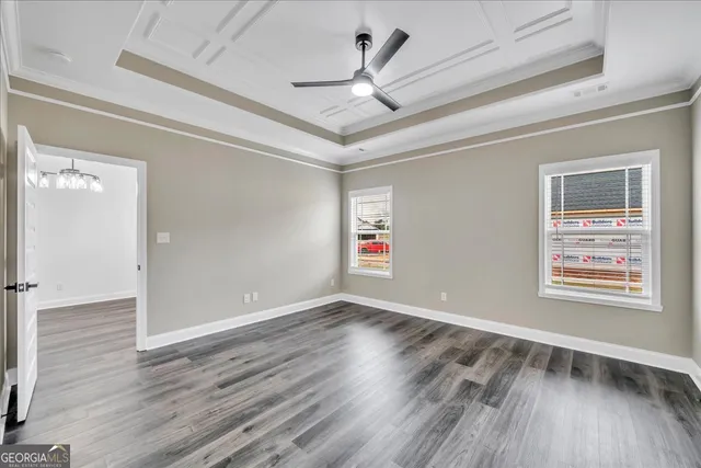 a view of an empty room window and wooden floor