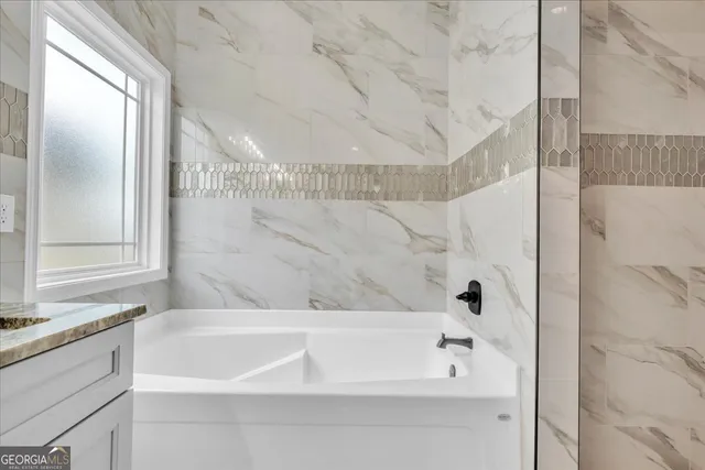 a bathroom with a bathtub and shower