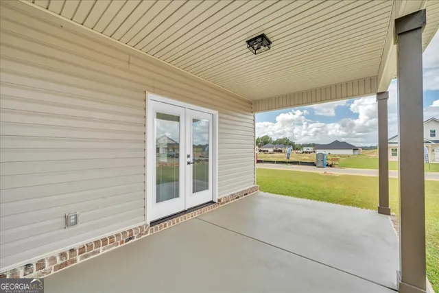 a view of an empty room with a window and brick walls