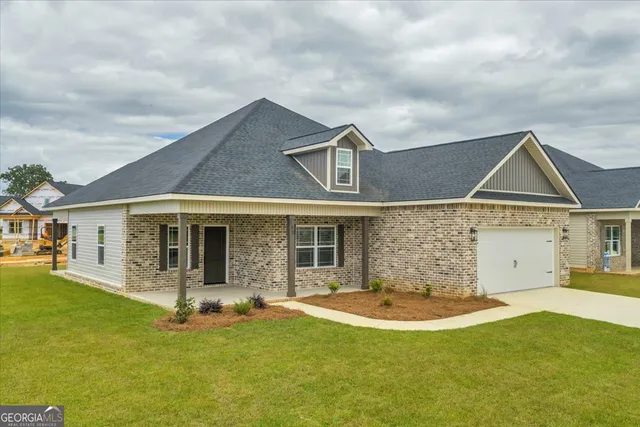 a front view of a house with a yard