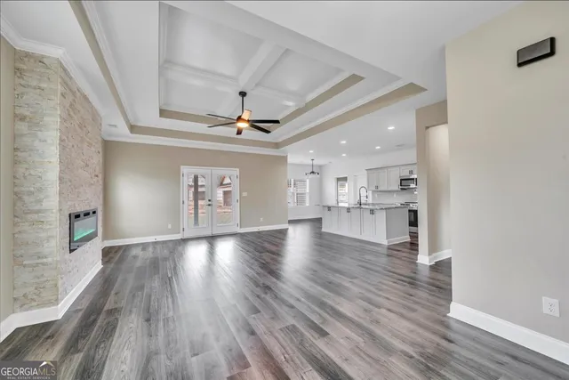 a view of empty room with wooden floor